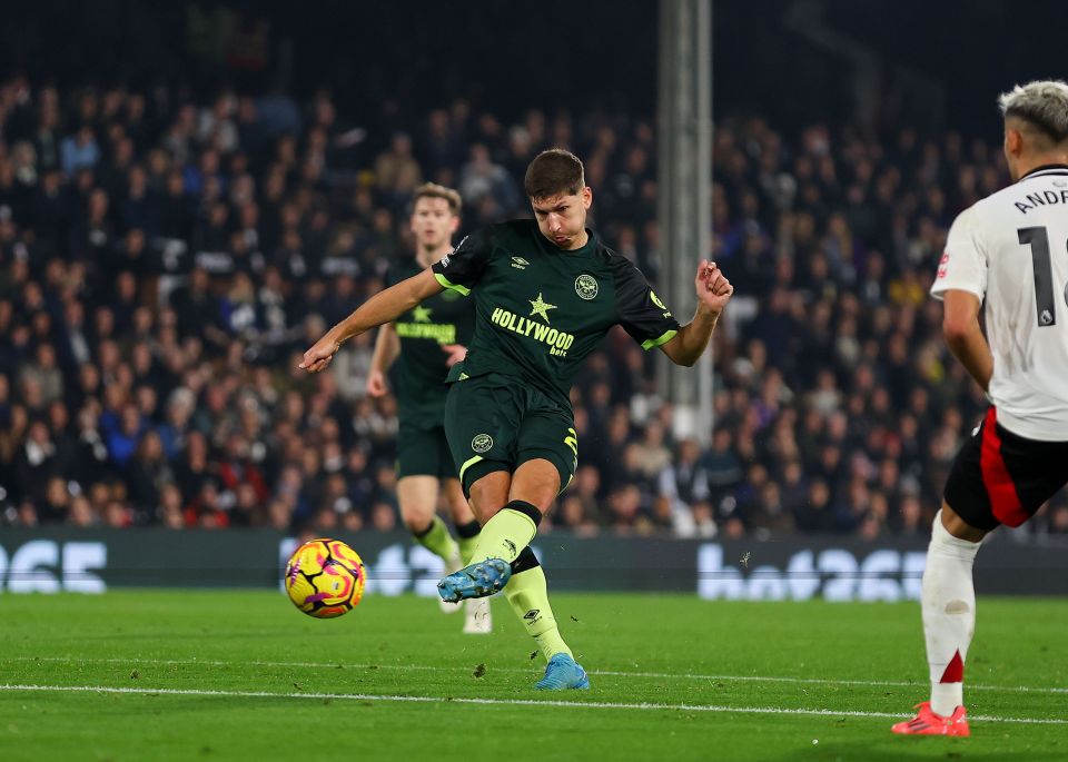 a soccer player wearing a hollywood jersey kicks the ball