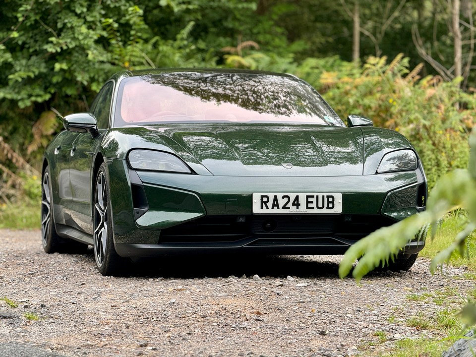 a green sports car with a license plate that says ra24 eub