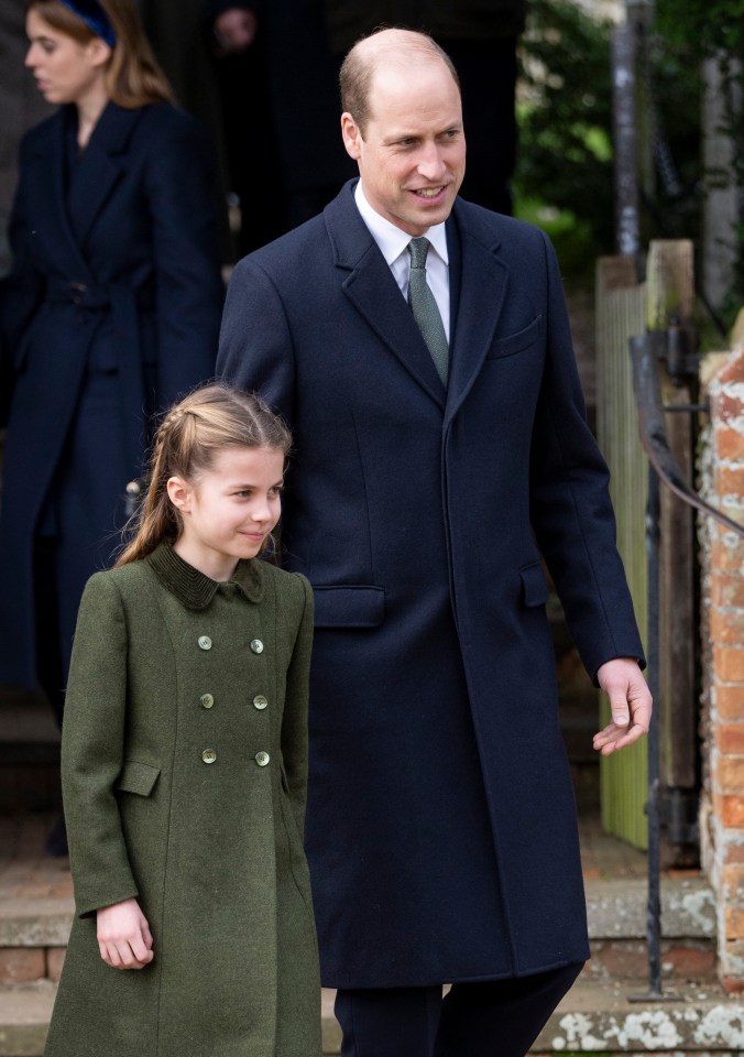 a man in a suit and tie stands next to a little girl in a green coat
