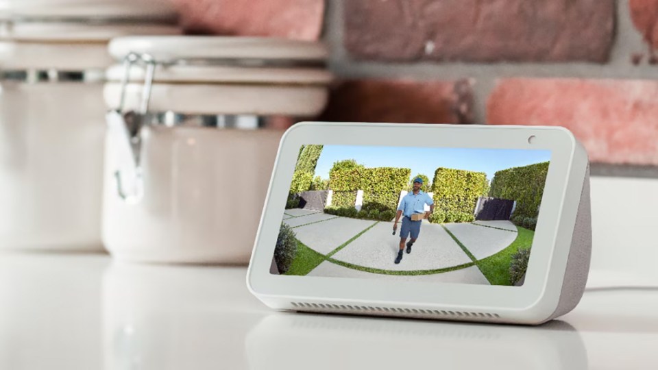 a smart device displays a picture of a man walking down a driveway