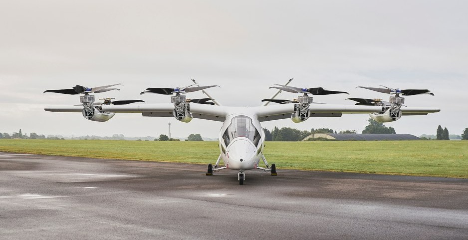 White hybrid electric aircraft on tarmac.
