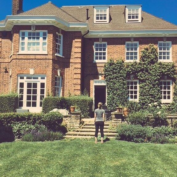Woman standing in front of Ricky Gervais and Jane Fallon's house.