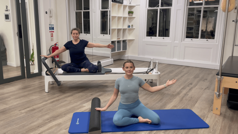 Two women demonstrating Pilates exercises at home.