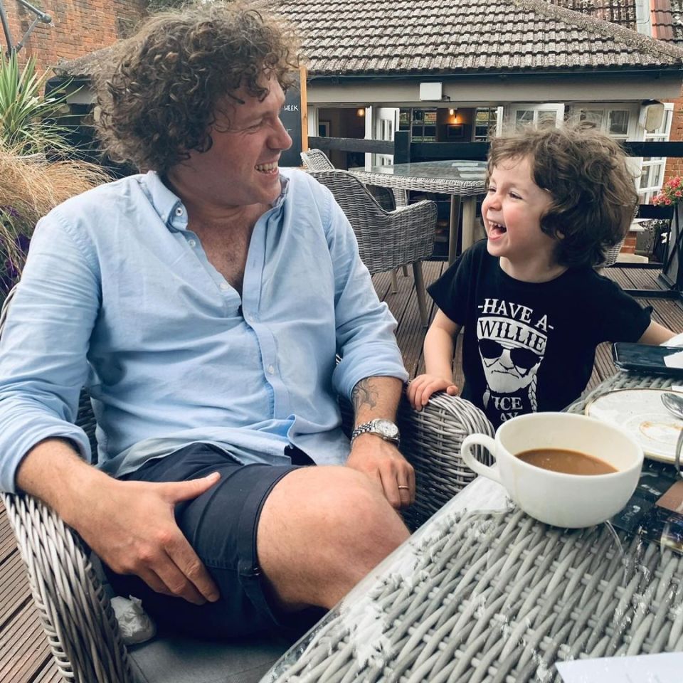 Jack McManus and his son Rafferty Jack McManus sitting together at a table outdoors.