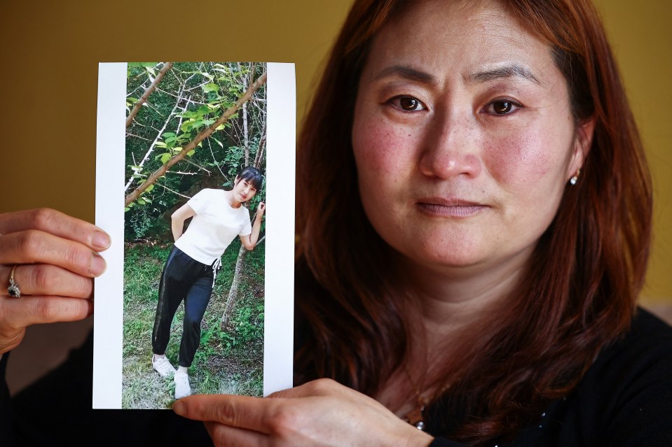 Woman holding photo of her missing sister.