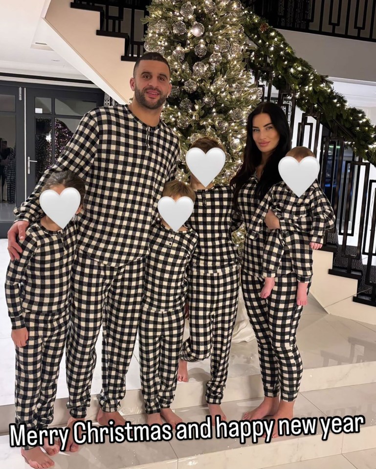 Kyle Walker and family in matching pajamas by a Christmas tree.
