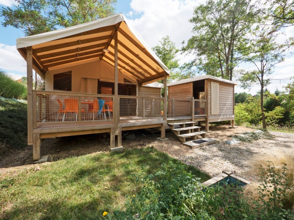 Wooden cabin rentals at a campsite.