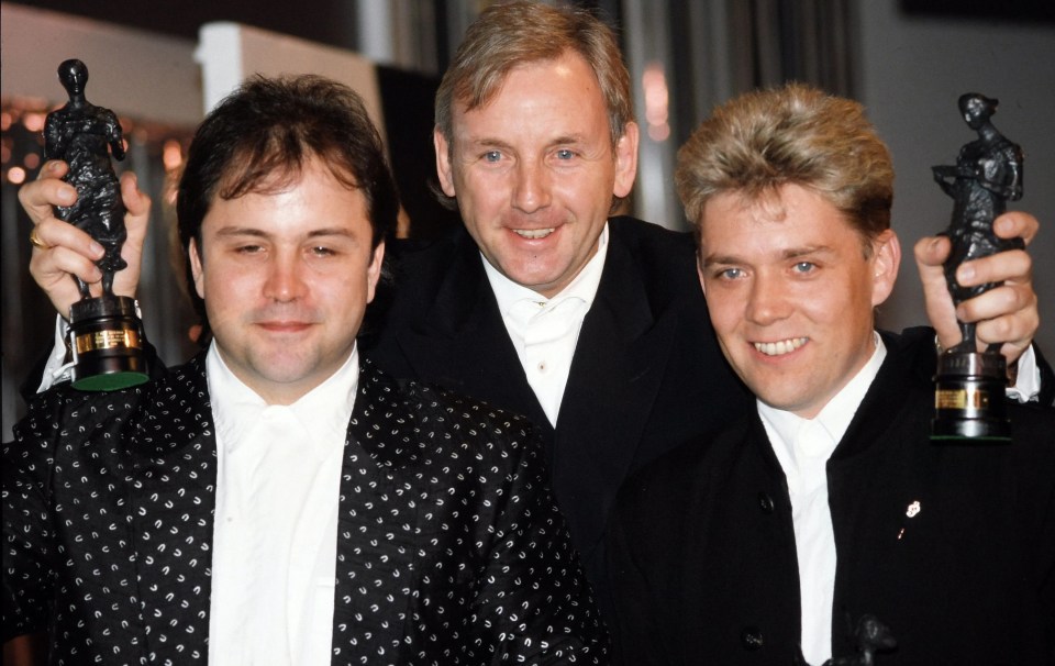 Stock Aitken Waterman in 1990 holding awards.