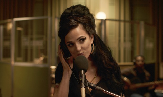Marisa Abela as Amy Winehouse recording in a studio.