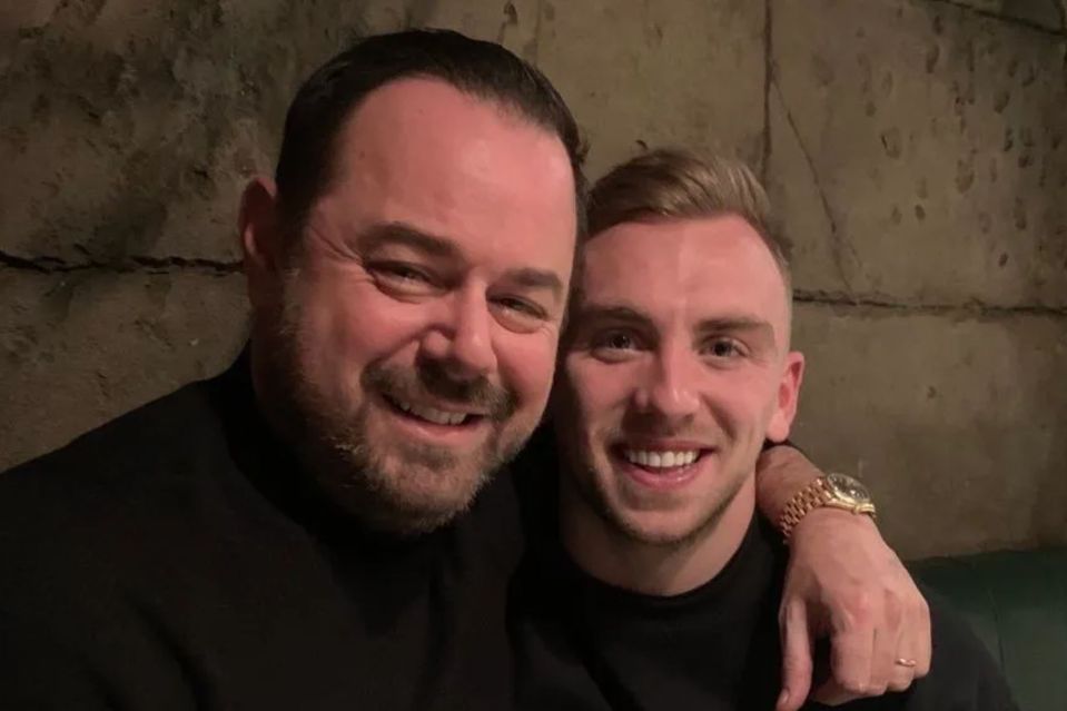 Two men smiling for a selfie.