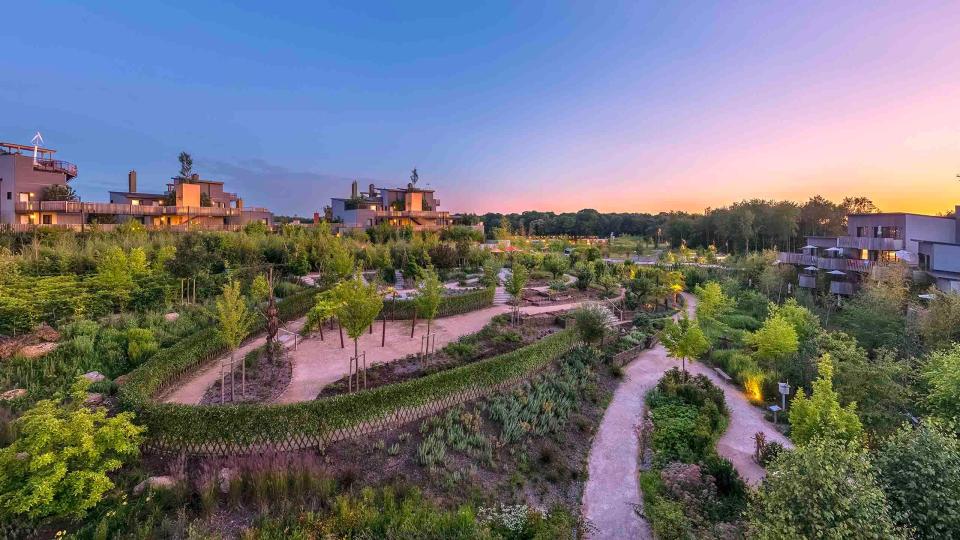 Aerial view of Villages Nature Paris at sunset.