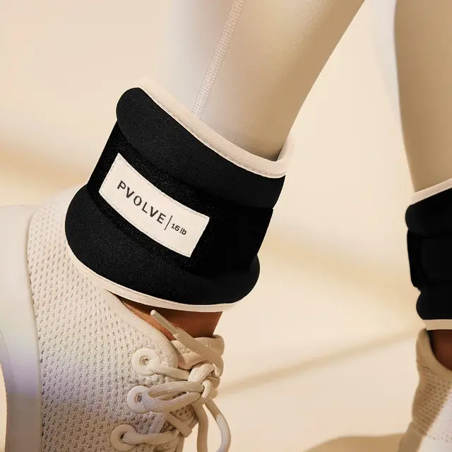 Pvolve 1.5 lb ankle weights on a person's ankles.
