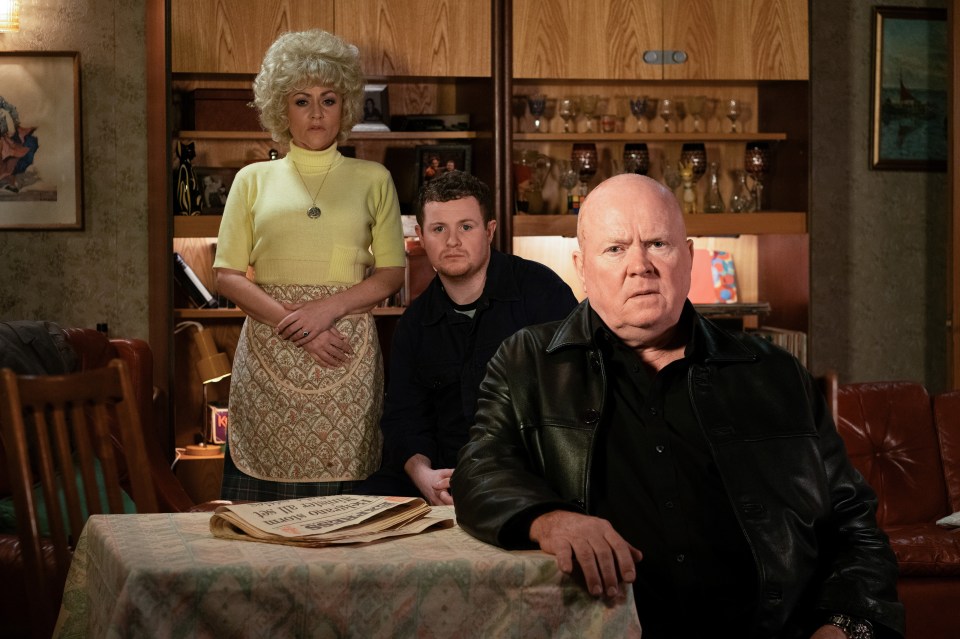 Scene from EastEnders featuring Peggy Mitchell, Phil Mitchell, and another man.