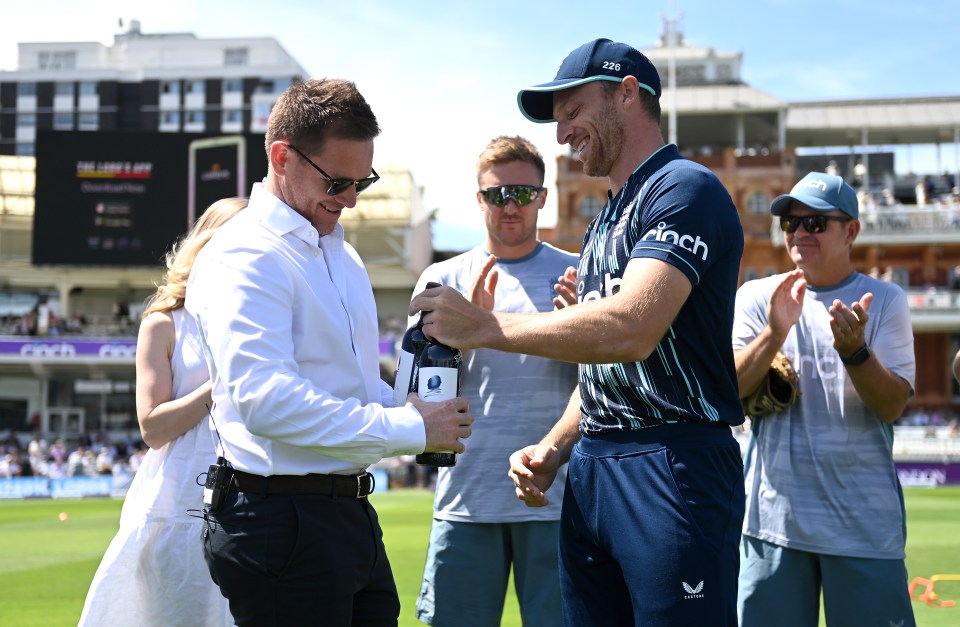 Jos Buttler presenting Eoin Morgan with two bottles of wine at Lord's Cricket Ground.