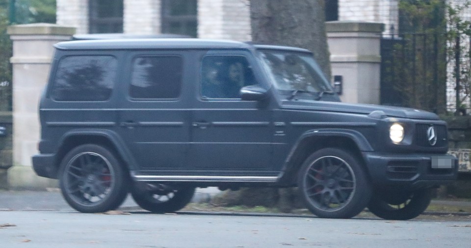 Tommy Fury leaving Molly Mae's mansion in a dark-colored SUV.
