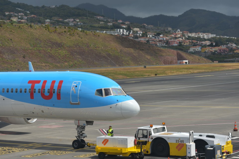 TUI Airways plane at an airport with flight cancellations due to severe weather.