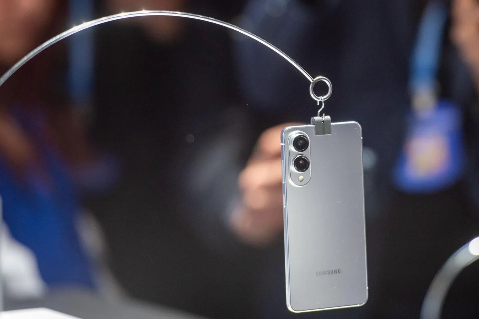 Samsung phone hanging from a display stand.