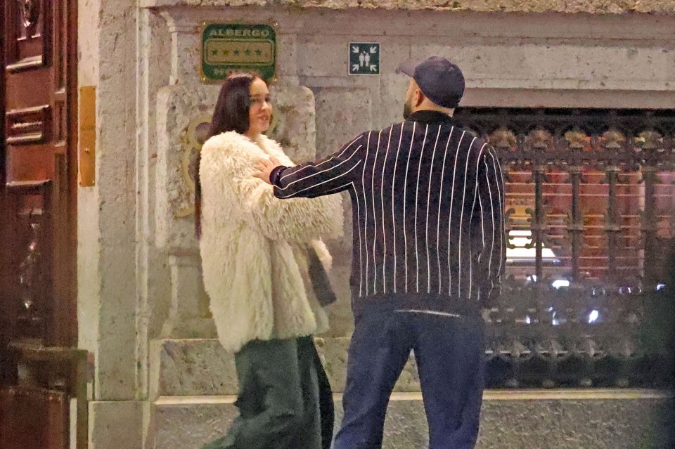 Kyle Walker and a woman outside a building at night.
