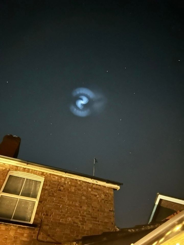 Spiral cloud of illuminated frozen fuel from a SpaceX rocket launch over the UK.