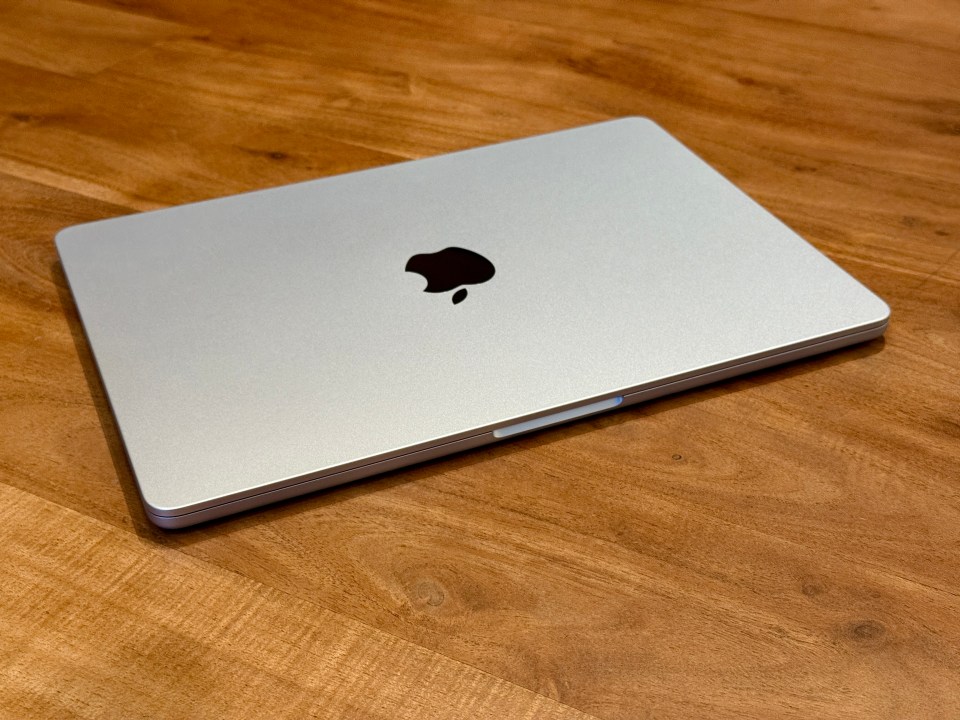 Silver Apple laptop on a wooden table.