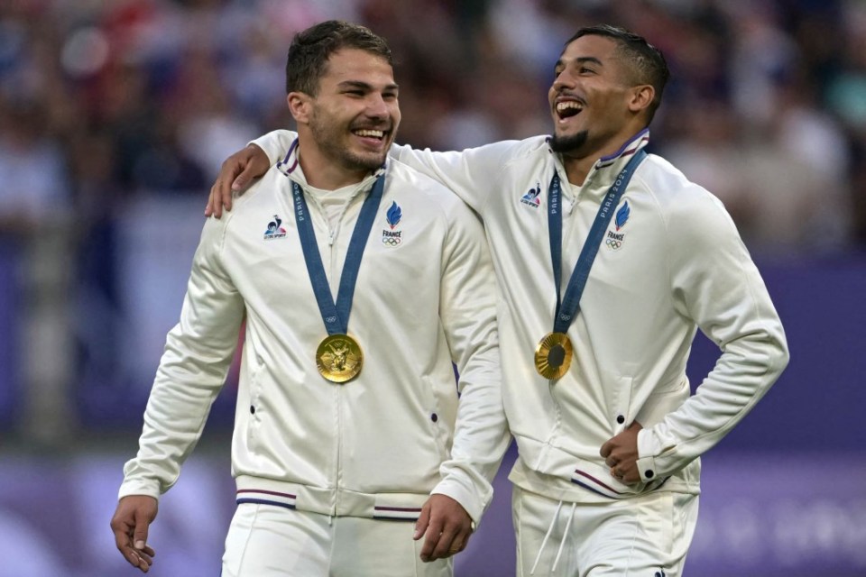 France's Antoine Dupont and France's Nelson Epee (R) celebrate with their gold medal during the victory ceremony following the men's gold medal rugby sevens match between France and Fiji during the Paris 2024 Olympic Games at the Stade de France in Saint-Denis on July 27, 2024. (Photo by CARL DE SOUZA / AFP) (Photo by CARL DE SOUZA/AFP via Getty Images)