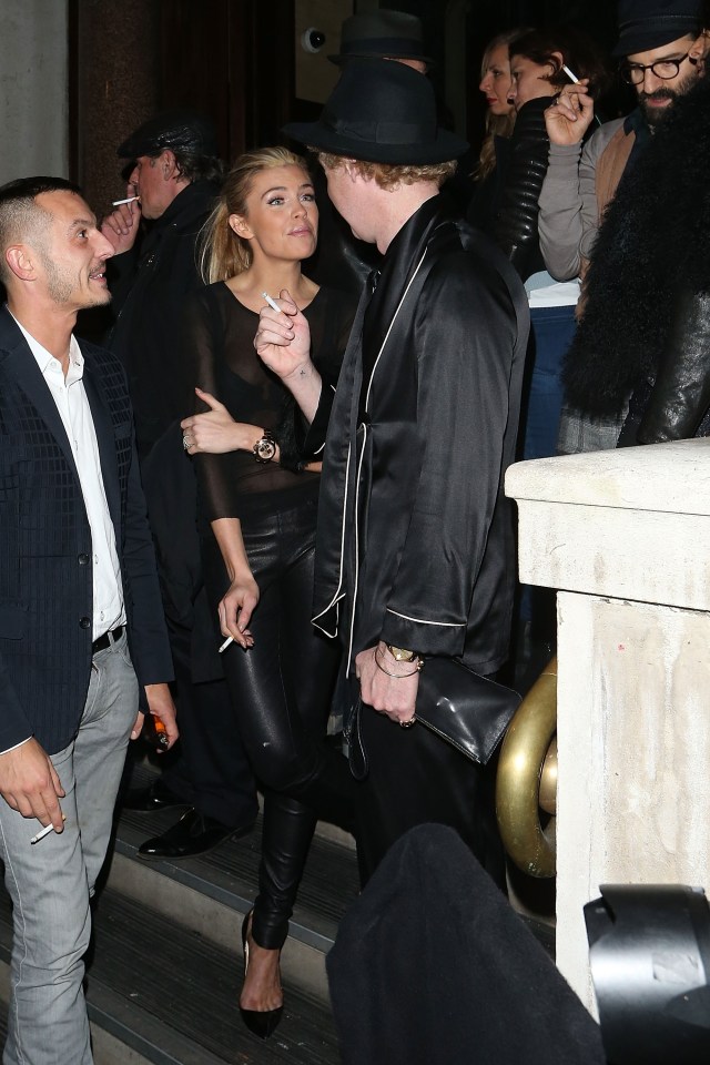 Abbey Clancy and James Brown smoking outside.