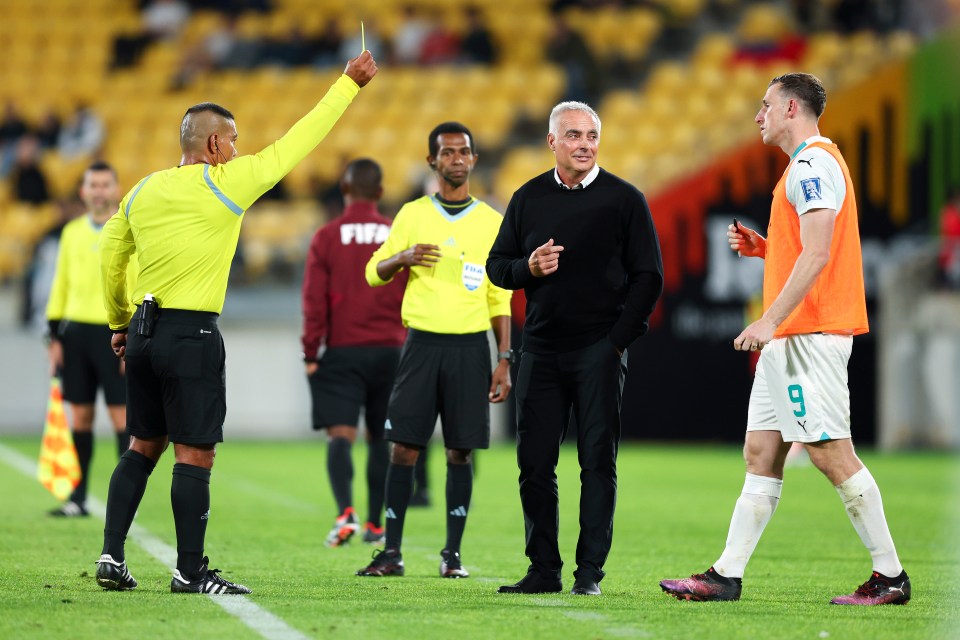 Referee showing Chris Wood a yellow card during a soccer match.