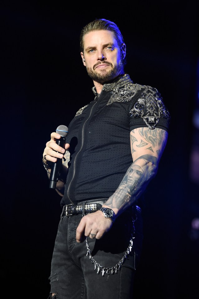 Keith Duffy of Boyzone performing on stage.