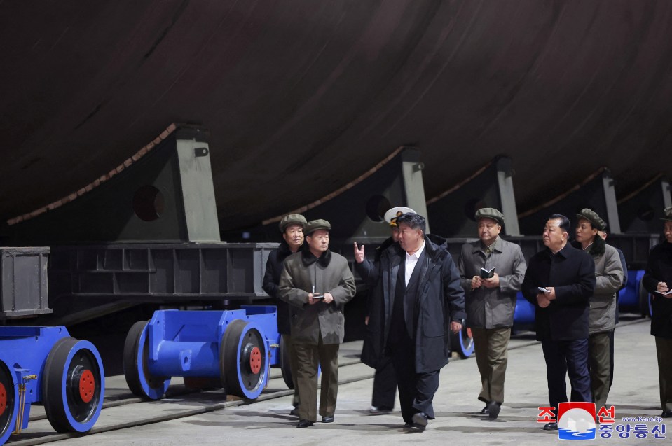 Kim Jong Un inspecting a nuclear submarine under construction.