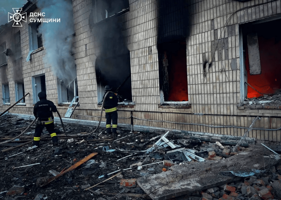 Firefighters battling a fire in a damaged building.