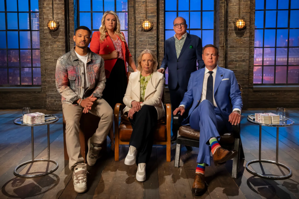 Group photo of five people sitting in chairs.