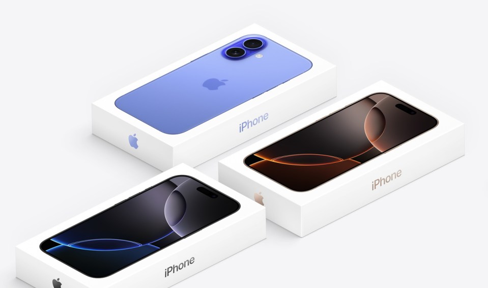Three iPhones in different colors in their boxes.