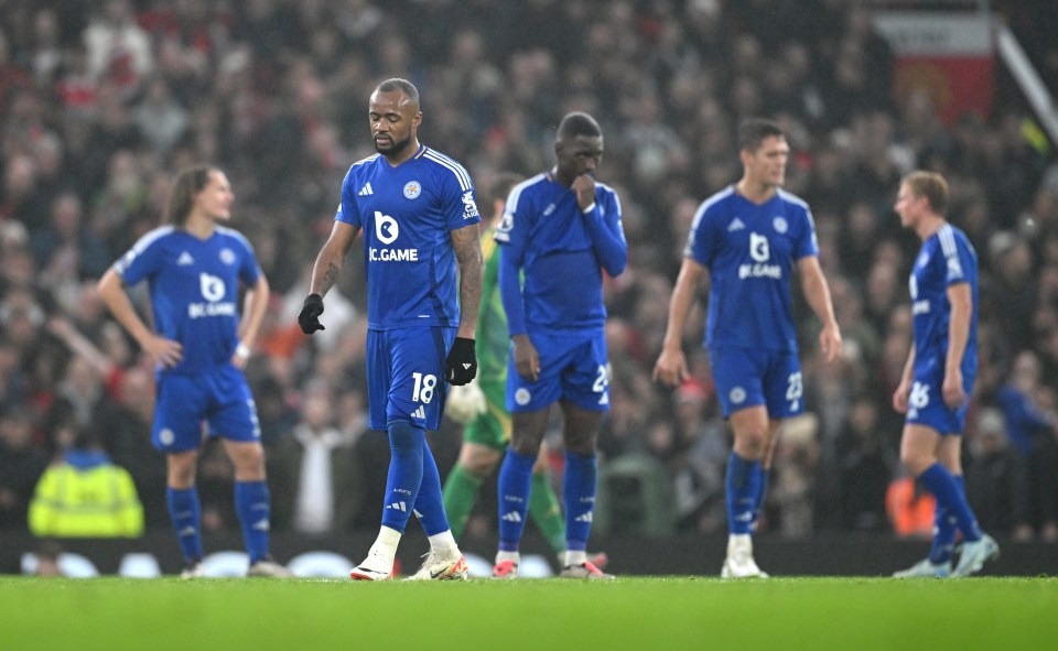 Leicester City players looking dejected on the field.