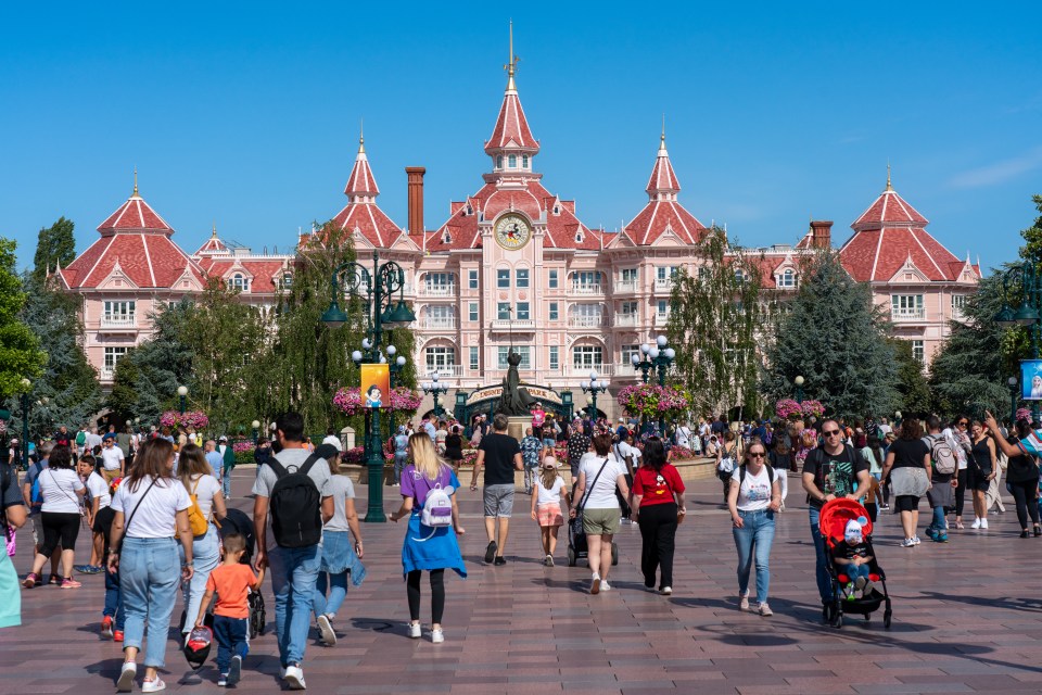 People walking in front of the Disneyland Paris hotel.