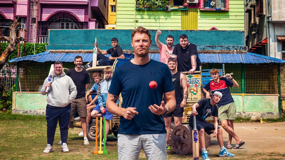 Freddie Flintoff with a group of young men playing cricket in India.