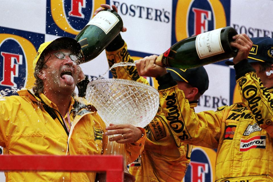 Race winner Damon Hill spraying champagne on Eddie Jordan.