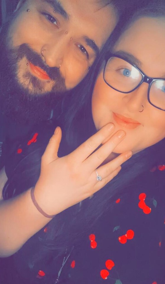 Close-up photo of a couple, the woman showing off her engagement ring.
