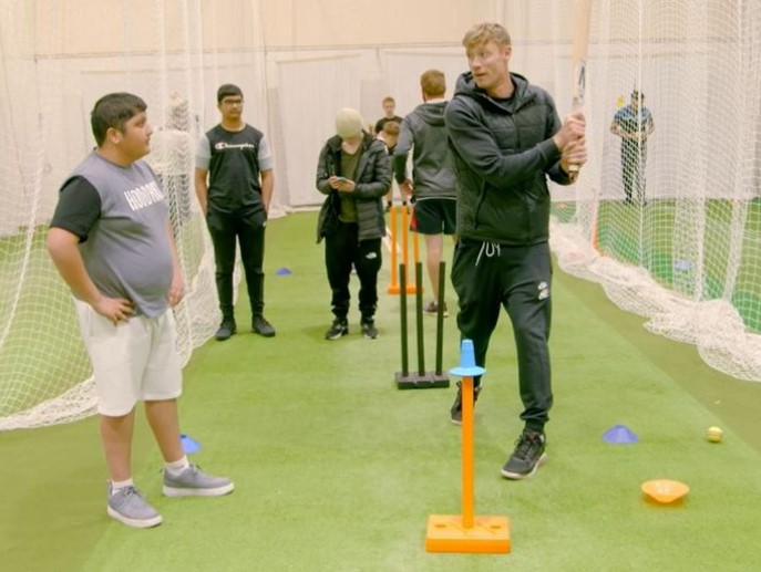 Freddie Flintoff coaching young cricketers.