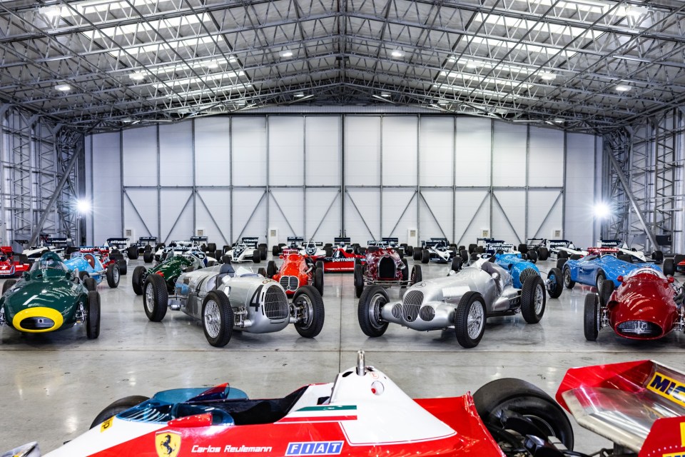 Collection of classic red Formula One race cars.