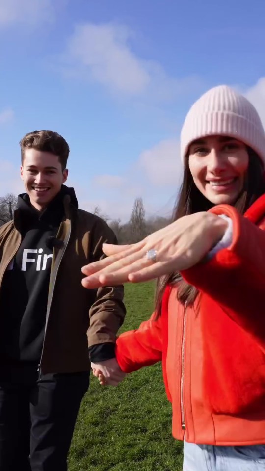 A woman showing off her engagement ring to her fiancé.