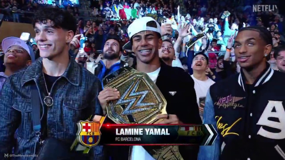 Lamine Yamal of FC Barcelona holding a championship belt, surrounded by people.
