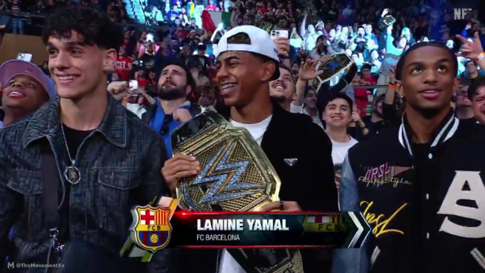 Lamine Yamal of FC Barcelona holding a wrestling championship belt, surrounded by people.