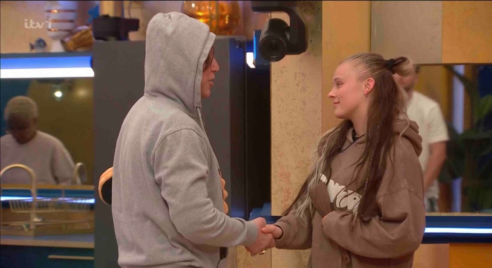 Mickey Rourke and JoJo Siwa shaking hands.