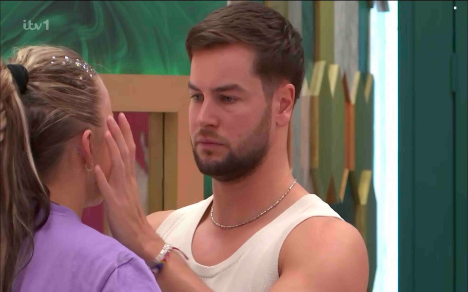 Chris Hughes comforts JoJo Siwa in a brightly colored bathroom.