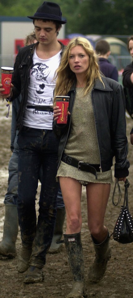 Kate Moss and Pete Doherty walking backstage at the Glastonbury Festival.