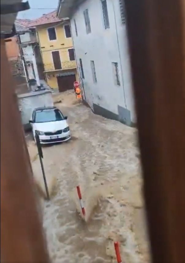 Flooded Italian street with a car.