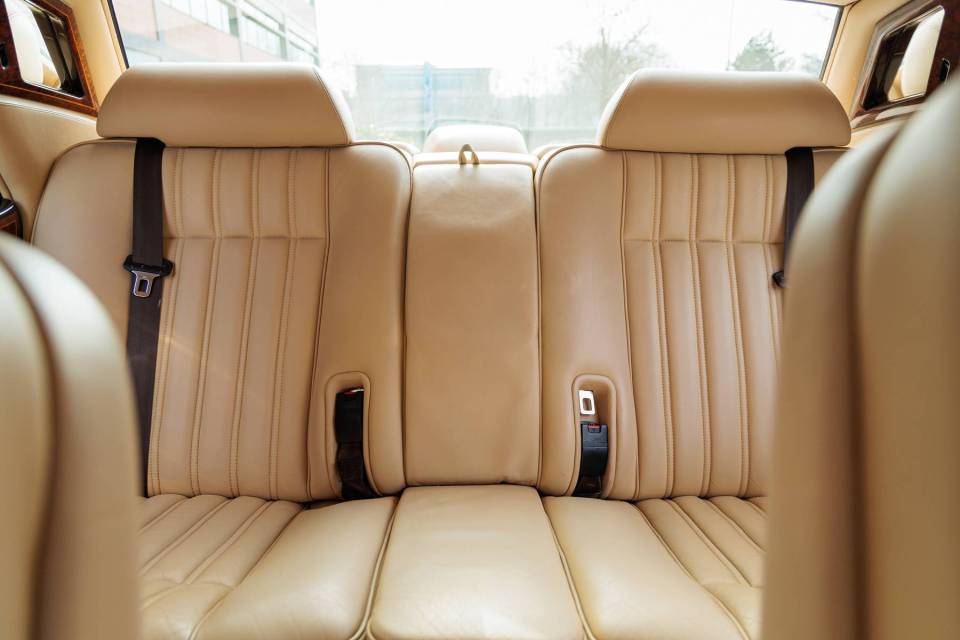 Cream leather back seats of a Rolls-Royce Silver Dawn.