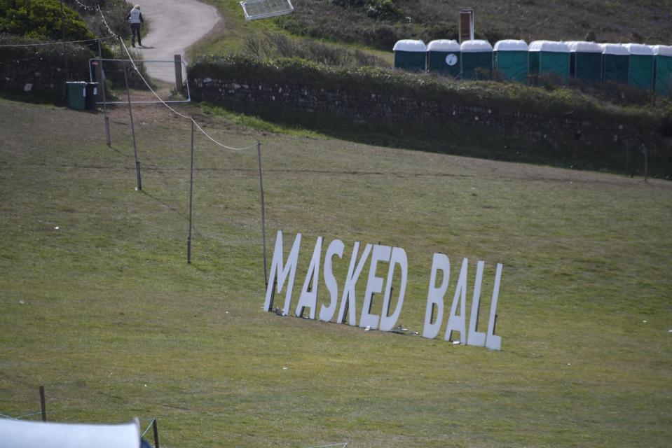 Large letters spelling out "Masked Ball" on a grassy field.