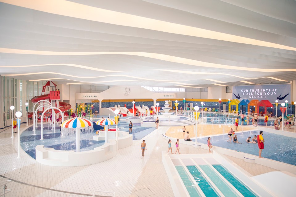 Indoor pool area with water features and slides.