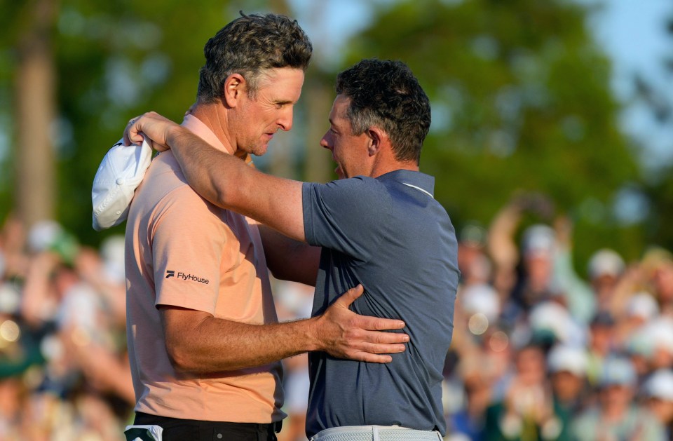Justin Rose and Rory McIlroy embracing on the 18th green after a playoff.